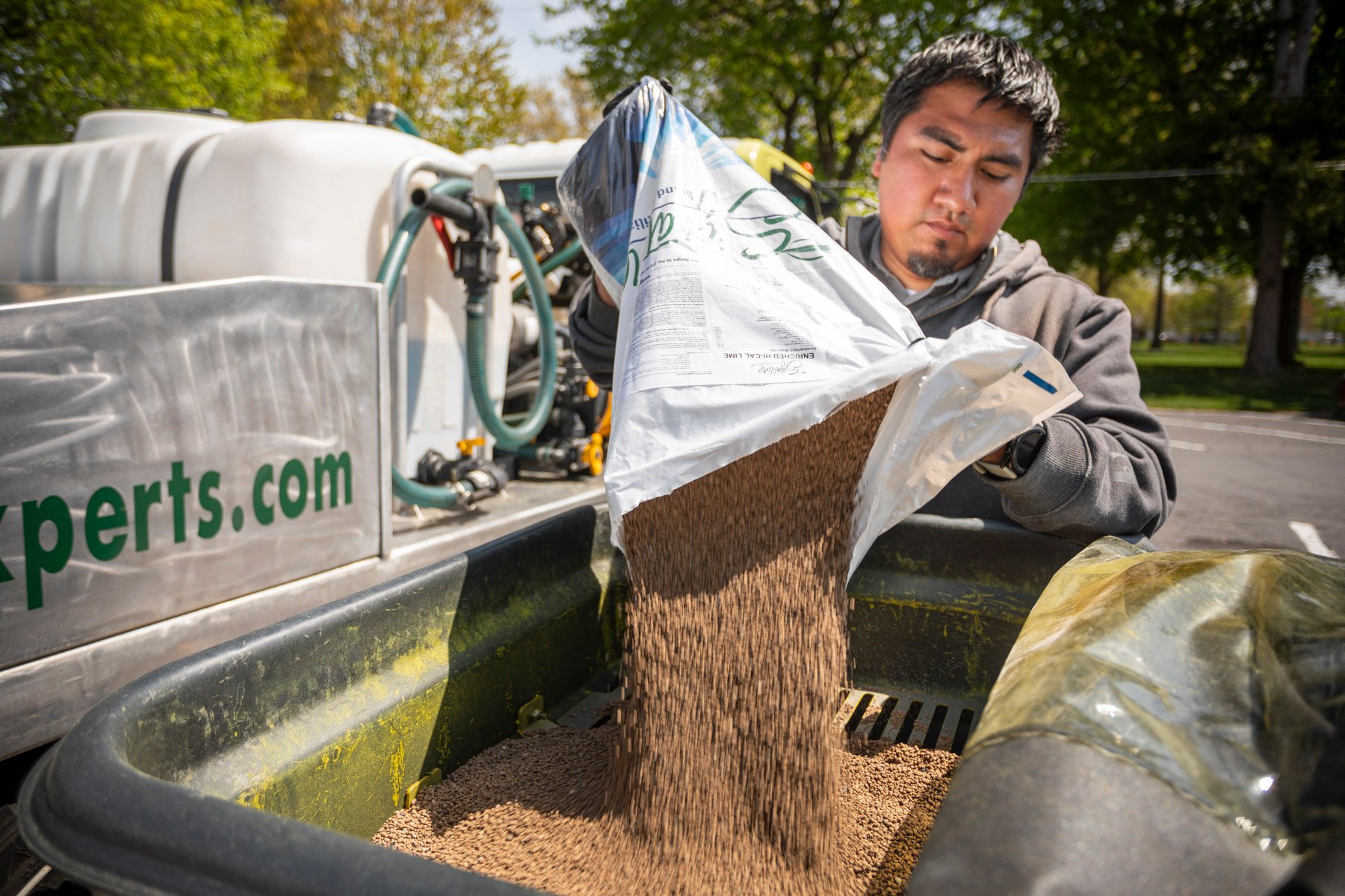 Lawn care technician limestone spreader 2