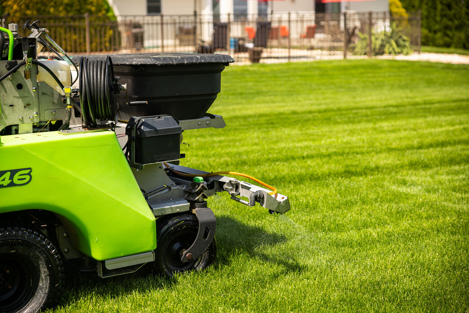 lawn care sprayer applying broadleaf weed control in nice yard