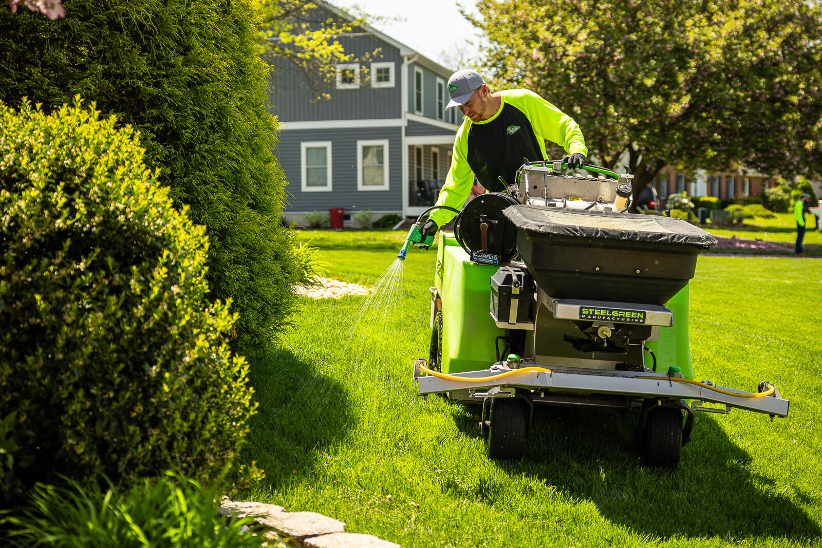 lawn care technician spraying a lawn edge for weed control 4