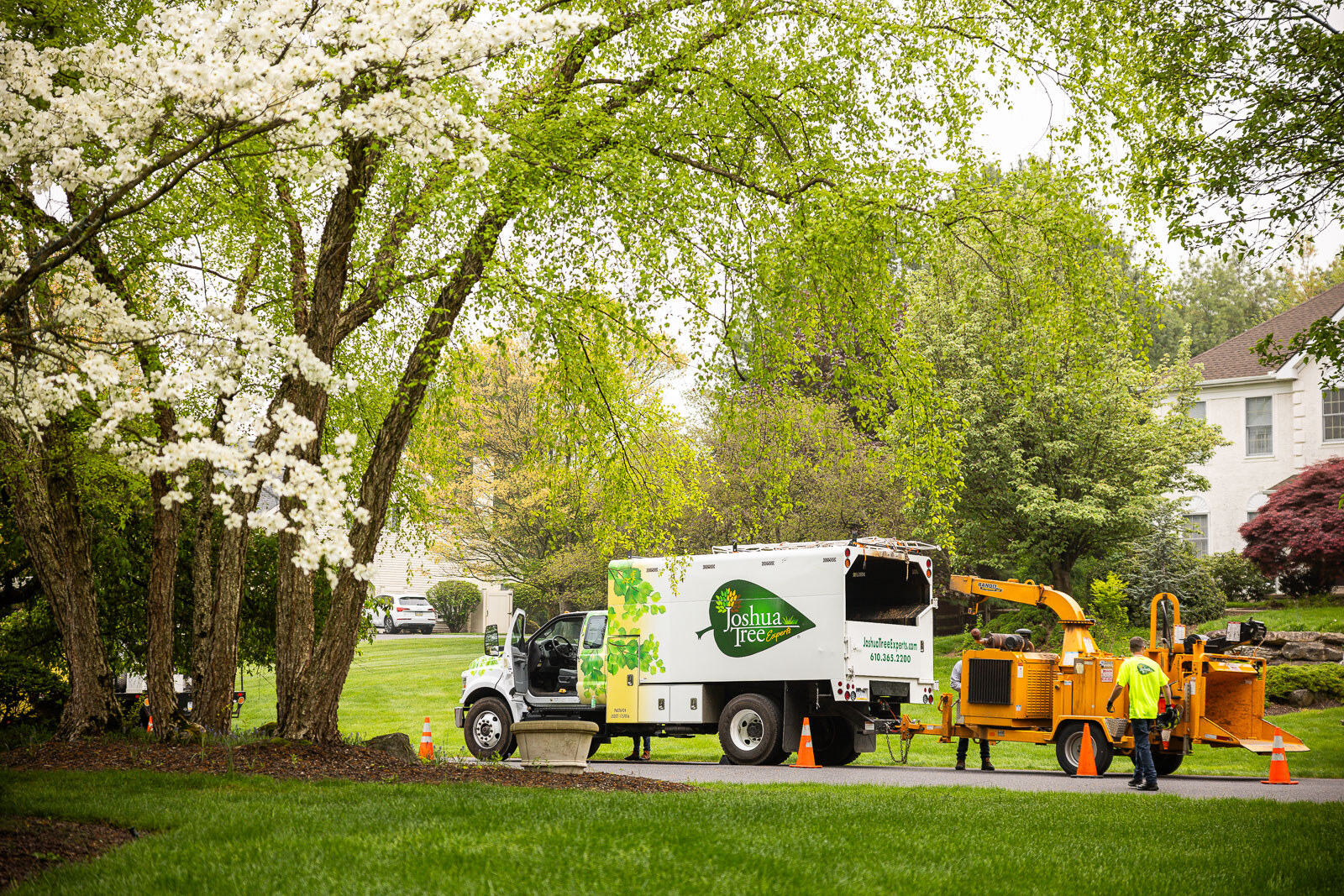 tree care technician with truck and chipper preparing for a job