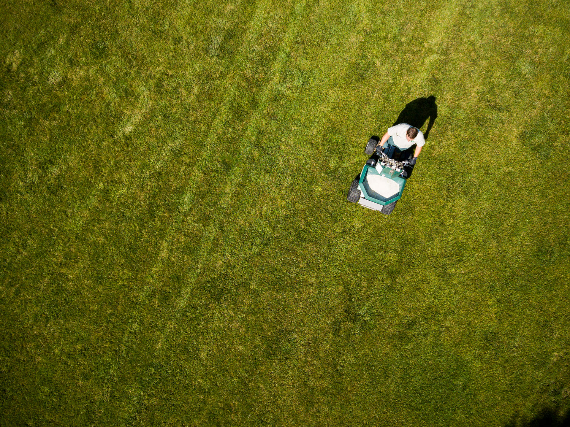 aerial view of lawn tech spraying fertilizer